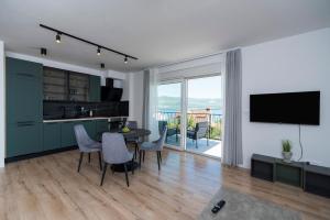 a kitchen and living room with a table and chairs at Luxury apartments Nicole in Trogir