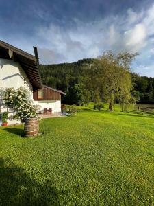a house in a field with a large yard at Ferienhaus Malterlehen in Marktschellenberg