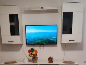 a flat screen tv hanging on a wall at Stan na dan BALANS in Ledine