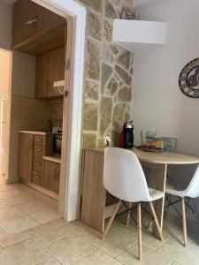 a kitchen with a table and chairs in a room at Seaside luxury in Lygia