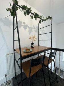 a table with a ladder with a plate of food on it at The Eaves - Victorian second floor, open plan apartment in Southport +3 photos