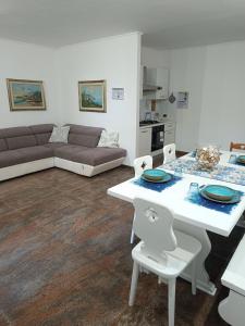 a living room with a couch and a table and chairs at Regina sul Mare in Terracina