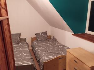 a small bedroom with two beds and a dresser at Maison de charme à 500m du port in Paimpol