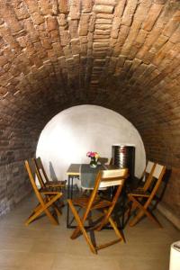 a dining room with a table and chairs in a tunnel at PodRoom Irena in Zmajevac