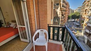 a white chair sitting on the balcony of a building at casa Aldini in Rome