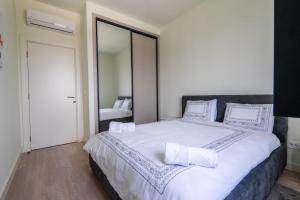 Postel nebo postele na pokoji v ubytování Libera Luxe Residence