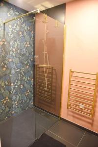 a shower with a glass door in a bathroom at SPA & SAUNA lin pour l'autre in Calais