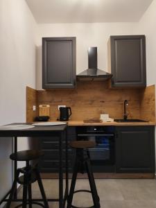 a kitchen with a counter and two bar stools at Studio apartman Ivor in Bale +35 photos