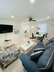 a living room with a blue couch and a table at ULTRA spacious apartment steps from the beach in Hollywood