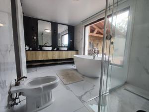 a bathroom with a bath tub and a sink at Casa do Vô Sousa in Pombal +29 photos