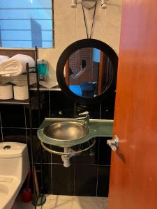 a person taking a picture of a mirror in a bathroom at Disfruta Boca del Rio in Boca del Río