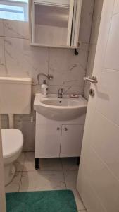ein weißes Badezimmer mit Waschbecken und Toilette in der Unterkunft Apartment Anis in Mostar