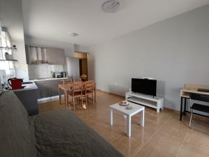 a living room with a couch and a table and a kitchen at Dimitra#RelaxHomeKallithea in Kallithea Halkidikis