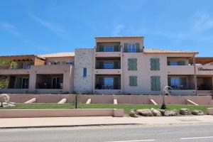 a large apartment building on the side of a street at Appartement Chez Emma, le luxe en Bord de Mer by Monarca in Saint-Florent