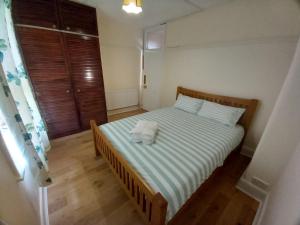 a bedroom with a bed with a towel on it at Sunshine in Hendon