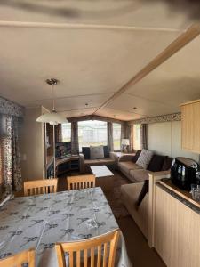 a living room with a table and a couch at Cosy caravan in Hull