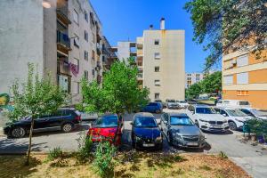 a group of cars parked in a parking lot at Stylish apartments - near Zadar bridge in Zadar