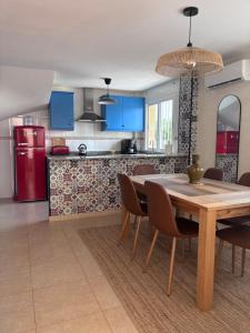 a kitchen and dining room with a wooden table and chairs at Playa de Miramar - 3 Min Walk to the Beach, Family-Friendly, Near Gandia in Miramar +27 photos