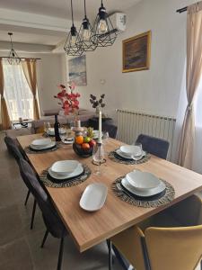 a wooden table with chairs and a dining room at Insula Apartment with Private Pool in Pučišća
