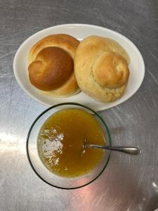 a plate of bread and a bowl of soup at Agriturismo Colle Dei Venti in Arsita