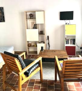 a living room with a wooden table and chairs at Studio cœur de ville in Auxerre
