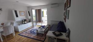 a living room with a couch and a table at Mima in Sarajevo +3 photos