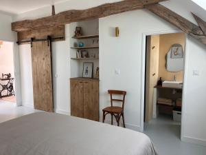 a bedroom with a bed and a desk and a chair at Le Meix Saint Vital in Barizey