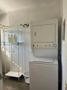a kitchen with a white refrigerator and a shelf at Condominio Marina Vallarta in Puerto Vallarta