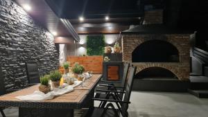 a long table in a room with a brick oven at Vista Verde in Zadoborje