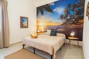 a bedroom with a bed and a painting of the beach at Casa Vacanze Verdemare con Piscina in Ribera +113 photos