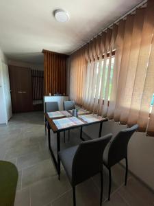 a dining room with a table and chairs at Apartmani Morava 54 in Kočino Selo +45 photos