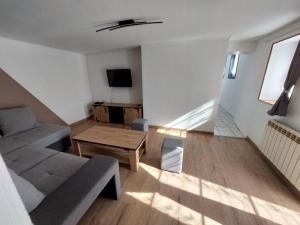 a living room with a couch and a table at Entre Tours et Loches in Tauxigny