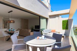 a balcony with a table and chairs and a living room at MADRESELVA 62.29 in Torre-Pacheco