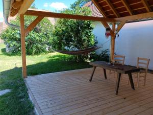 a porch with a hammock and a table and chairs at Ferienhaus Himmelreich in Kaisersdorf
