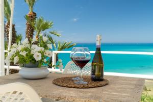 a bottle of wine and a glass on a table at Casa Vacanze Verdemare con Piscina in Ribera
