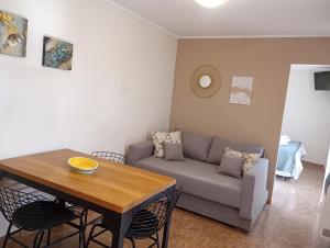 a living room with a couch and a table at De Los Andes Hotel Boutique in Ciudad Lujan de Cuyo