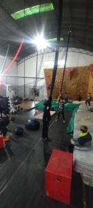 a group of people in a gym with a climbing wall at Casa Qinti EcoHostel in Cosquín