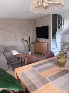 a living room with a table and a couch at Playa de Miramar - 3 Min Walk to the Beach, Family-Friendly, Near Gandia in Miramar