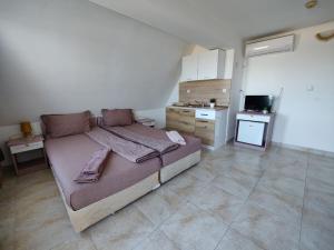 a bedroom with a large bed in a room at Hotel Joker in Lozenets