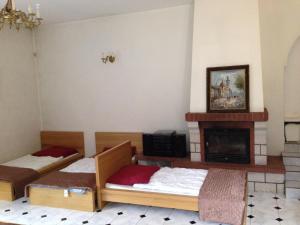 a room with two beds and a fireplace at Green Country Hostel in Piaseczno