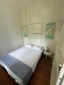 a bedroom with a large bed and a table at Hostel Los Pargos in Río Sequito +8 photos