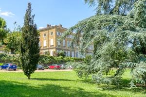 a large building in the background with trees in the foreground at Séjourner au Château de la Roue Grand appartement in Lissieu