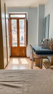 a room with a table and a wooden door at Borgo Insieme in San Donato Val di Comino +17 photos