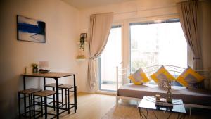 a living room with a couch and a large window at C&C Studio - Comfy Nest Near Airport & City Access in Vantaa