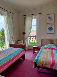 a bedroom with two beds and a balcony at La Maison Chaudenay in Chaudenay +54 photos