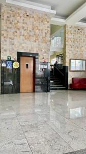 a lobby with a door and stairs in a building at Alvorada Palace Hotel de Poços in Poços de Caldas