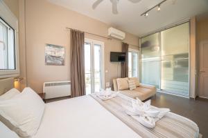 a bedroom with a large white bed and a couch at Villa Sorina Kefalonia in Svoronata +139 photos