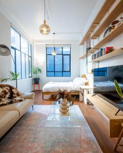 a living room with a couch and a table at Heart of The City in Auckland