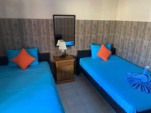 Postel nebo postele na pokoji v ubytování Lita Homestay