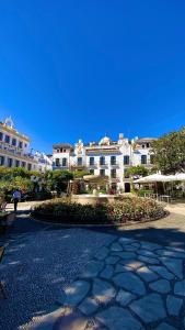 a view of a large building with a stone walkway at Loving Mediterranean Home in Estepona